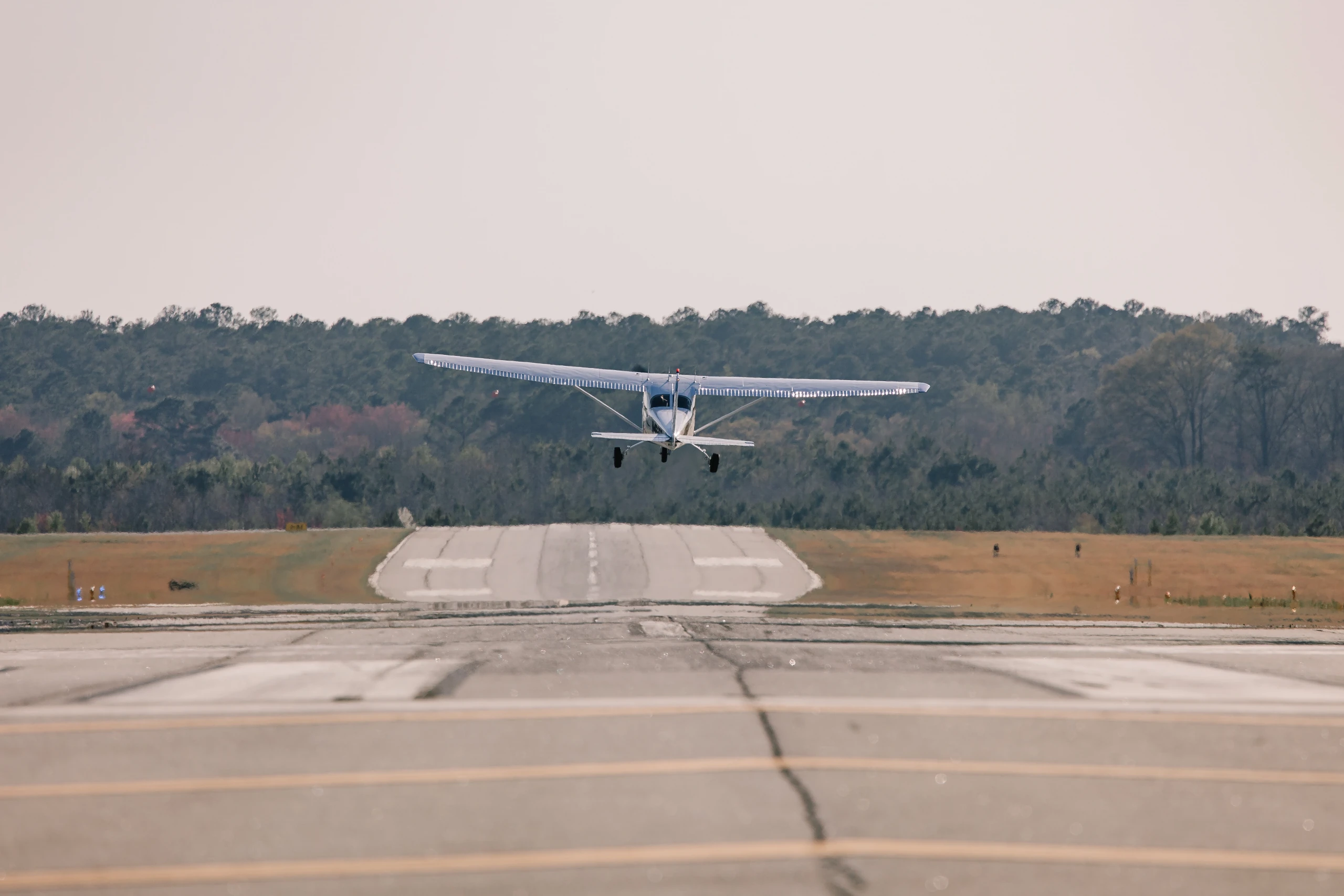A Speedway Flight Training airplane taking off from the runway near Atlanta
