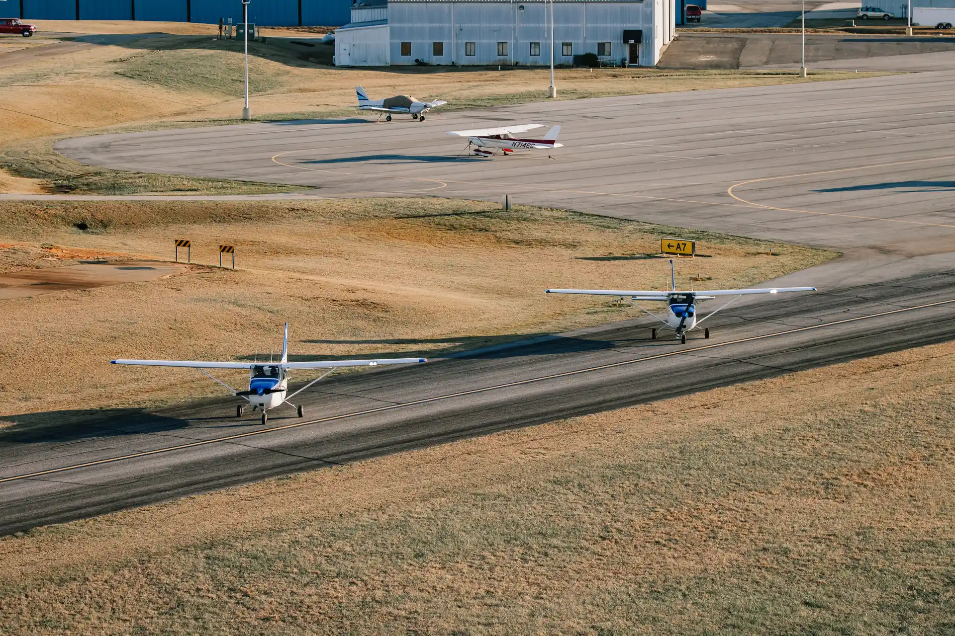 Two Speedway Flight Training Cessna 172s taxiing on the runway at Atlanta Speedway Airport